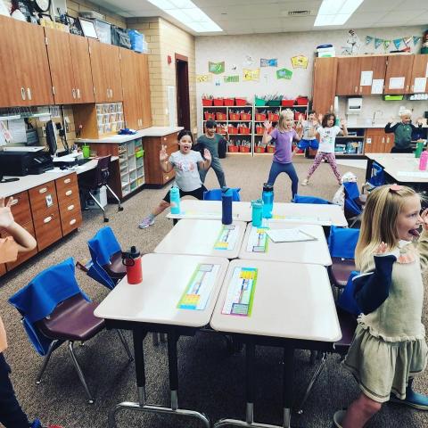 Ms. Hayes first grade class does yoga.