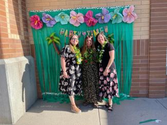 Students in front of flowery backdrop