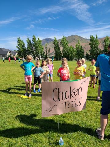 students at "Chicken toss" sign