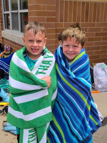 boys wrapped in towels