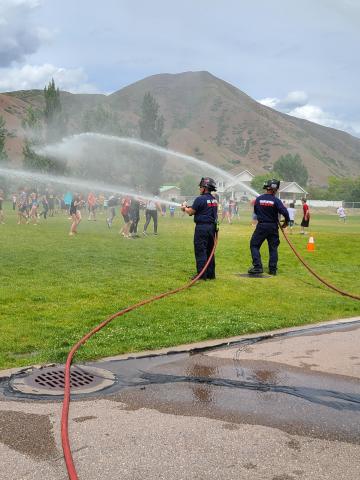 firemen spraying students