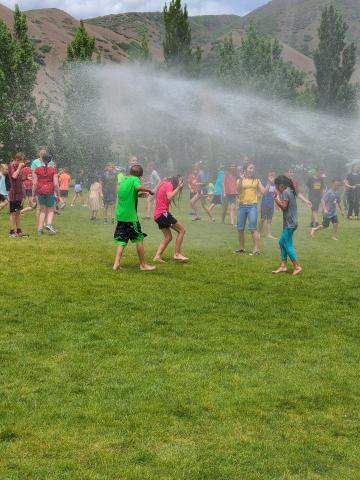 students being sprayed from fire hose