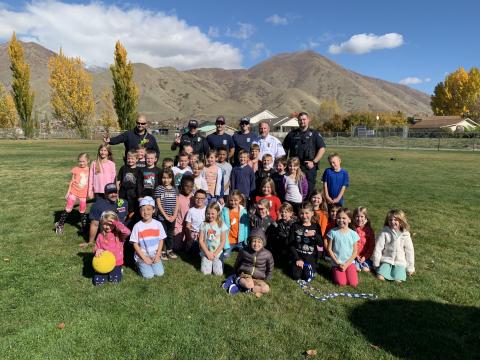 Mapleton Police Officers spend lunch time with students during Red Ribbon Week.