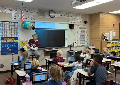 Maple Mountain High School Football Players reading to students. 