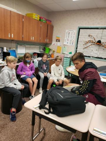 Maple Mountain High School Football Players reading to students. 