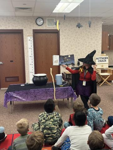 Mrs. Smith teaches descriptive writing reading Room on the Broom.