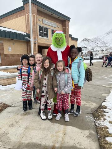 The Grinch welcoming students to school.