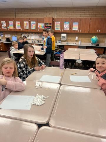 Building cubes in Math Olympiads with marshmallows and toothpicks.