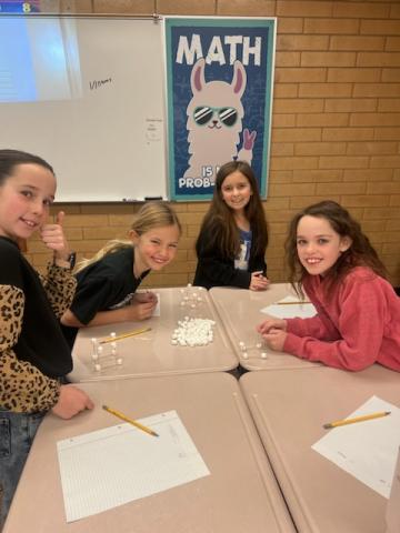 Students building cubes in Math Olymiads.